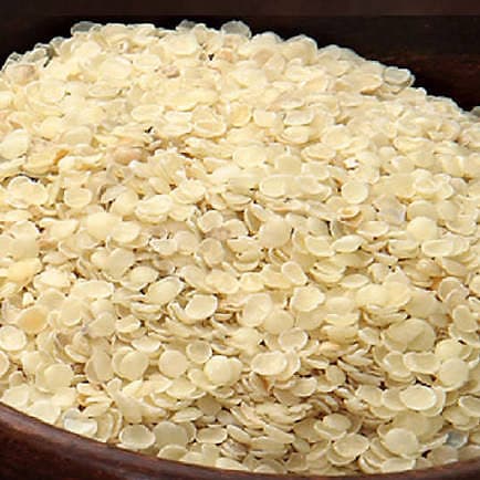 Guar gum splits in a bowl, showing their flat halved shape